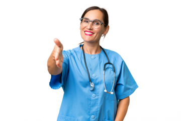 Middle-aged nurse woman over isolated background shaking hands for closing a good deal