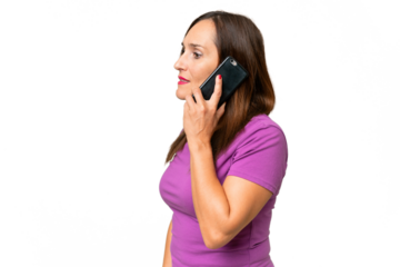 Middle-aged caucasian woman over isolated background keeping a conversation with the mobile phone with someone