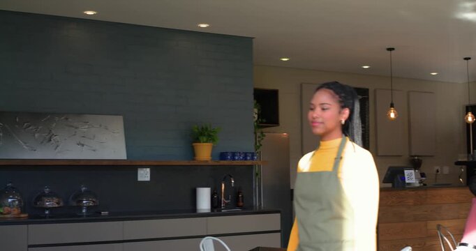 opening shot showing barista delivering coffee cups then walking toward entrance and waving - Powered by Adobe