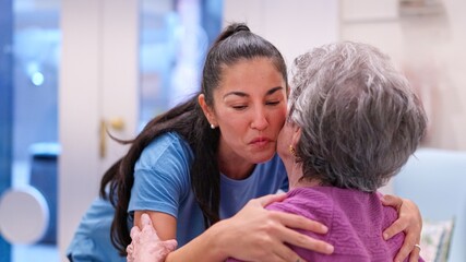 Fototapeta premium Granddaughter showing love and care to grandmother in nursing home
