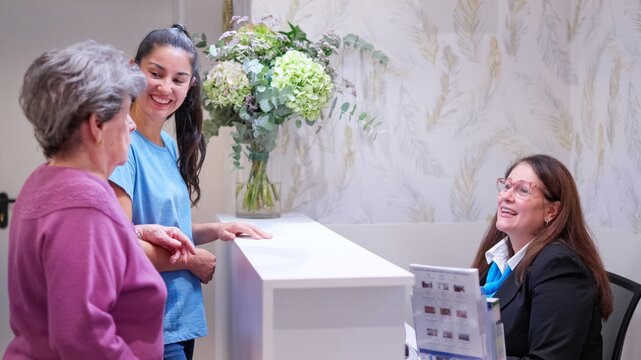 Granddaughter visiting grandmother at nursing home reception