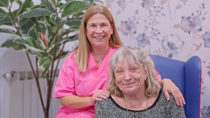 Caregiver woman providing support to elderly lady