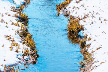 a spring brook passing through a meadow
