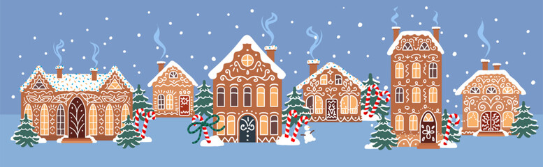 Cozy gingerbread town with decorated cookie houses, snowy winter trees and falling snow on a blue night background. Cute bakery style landscape for holiday designs and greeting cards.