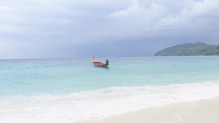 A fishing boat waits and monitors rough sea conditions to determine whether it is safe to head out for fishing.