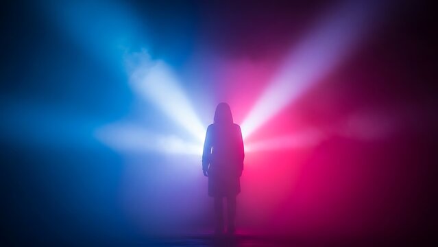 Silhouette of a person standing in dramatic red and blue neon lights and smoke
