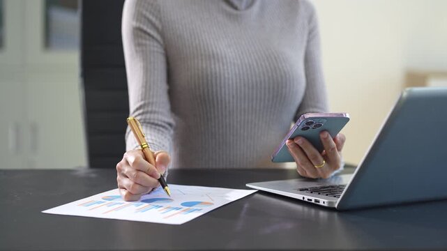 Business woman working on laptop and accounting financial report, accountant using calculator to calculate tax refund at office