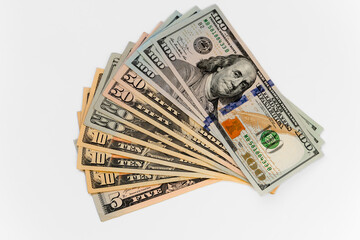New dollar banknote USA of different denominations folded like a fan.  Top view white background, isolated.