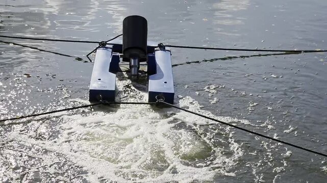 Floating paddlewheel aerator operating in water. 