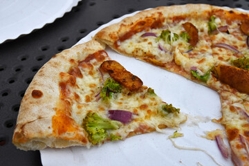 Pizza with broccoli and potatoes on a plate