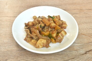 Stir fried slice fat pork belly with pineapple and black ear mushroom with soy sauce on plate