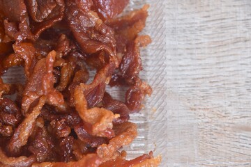 salty and sweet dry fried slice pork meat fermenting in soy sauce on transparent plastic packaging box