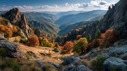 Scenic vista showcases hiking path winding through autumn mountain landscape in Tatry National Park, Poland, with colorful foliage and rocky peaks under blue sky