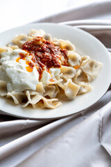 Close-Up of Turkish Manti Dumplings on a White Plate