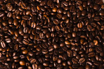 Close-up view of roasted coffee beans showcasing rich textures and deep brown hues, perfect for coffee lovers and culinary enthusiasts