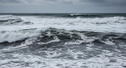 Dramatic Ocean Waves Crashing Under a Cloudy Sky.