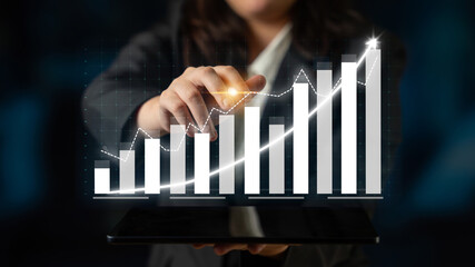 A businesswoman analyzes financial growth data using a digital chart displayed on a tablet. This modern office scene highlights trends and insights in business strategy. Impute