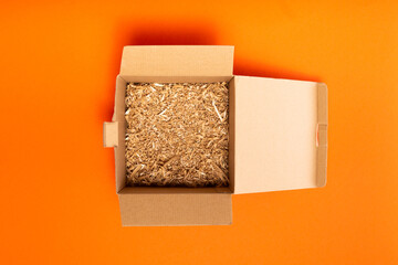 Cardboard box on orange background