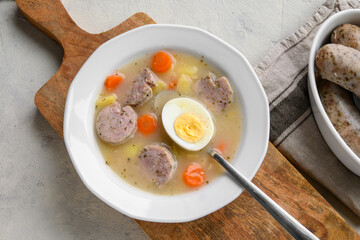 Sour soup with sausage and egg, traditional Polish soup