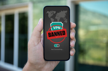 man hand hold phone with Vpn banned on screen street