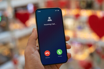 man hand hold phone with incoming call on screen Christmas