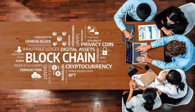 A team of professionals collaborates on blockchain technology, analyzing cryptocurrency and digital assets while exploring smart contracts and transaction processes at a modern workspace. Amity - Powered by Adobe