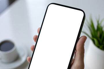 Female hand hold phone with white isolated screen background office