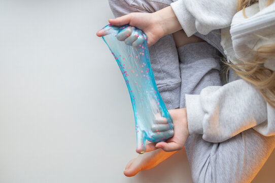 A child playing with a slime at home.