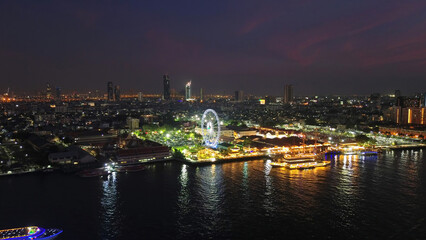 Fototapeta premium Skyscrapers and Ferris wheel in Bangkok city at night