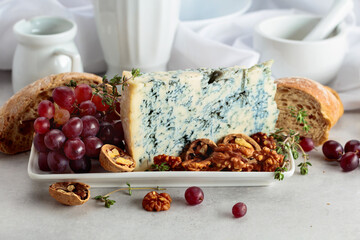 Gorgonzola cheese with walnuts, red grapes, and thyme.