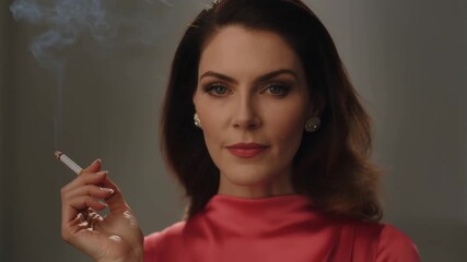 A woman is smoking a cigarette in a retro style Stock video