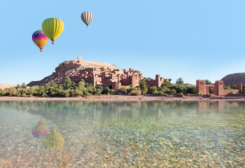 Hot air balloon flying over Ait Ben Haddou near Ouarzazate river - Atlas Mountains, Morocco, North...