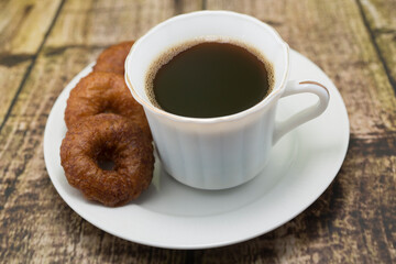 Coffee and Donuts on a Rustic Wooden Table
