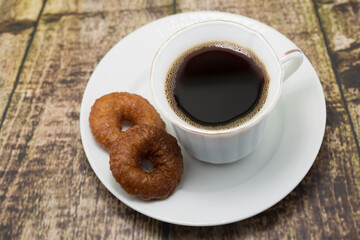 Fototapeta premium Coffee and Donuts on a Rustic Wooden Table