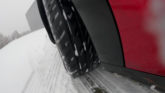 Car wheel sliding on snow during winter driving with ABS braking action