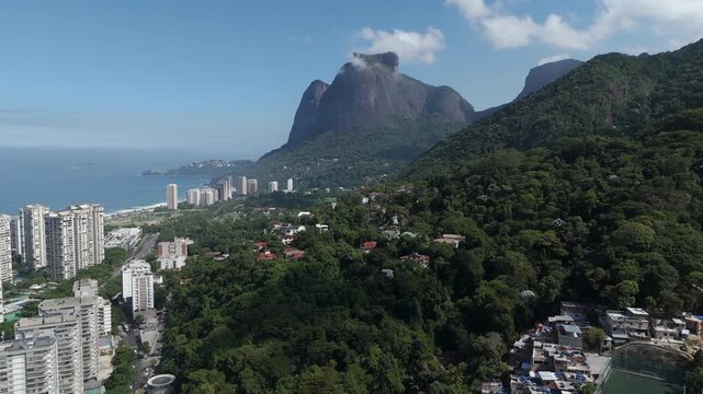 Aerial view of Pedra da Gavea and Favela da Rocinha on a sunny day in Rio de Janeiro, Brazil.
