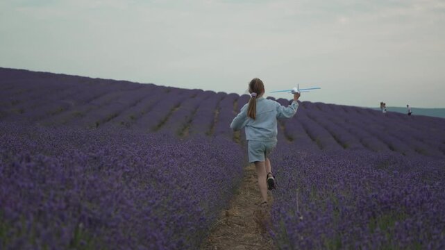 Child, running, lavender, happy girl playing with toy airplane in a beautiful purple field, dreams of flying.