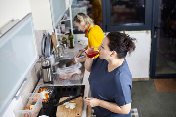 two mature woman same sex couple cooking dinner together, lifestyle people concept