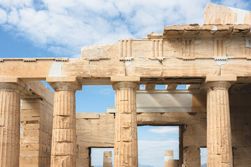 A detailed close-up of the Doric columns and marble architecture of the Parthenon at the Acropolis in Athens, with view through portal of cityscape sprawl of Athens, Greece.