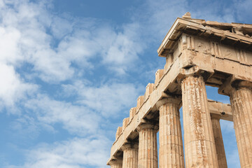 A detailed close-up of the Doric columns and marble architecture of the Parthenon at the Acropolis in Athens, showcasing the ancient stonework of this iconic Greek landmark.