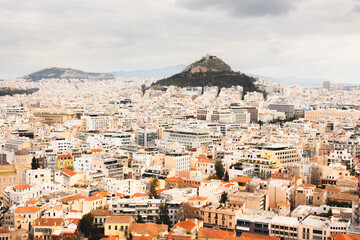 Cityscape view over the sprawling city of Athens, Greece and Lycabettus Hill from the Acropolis.