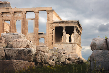 The ancient Erechtheion on the Acropolis in Athens, Greece, features the iconic Caryatid porch, classical columns, and historic statues, embodying the rich history and architecture of a significant ar