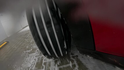 Car wheel sliding on snow with ABS braking action during winter driving