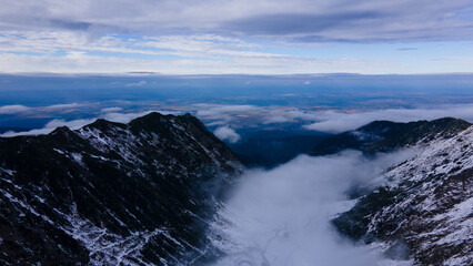 Aerial photography of a winding road in the mountains with serpentines and curves. Photography of transfagarasan road in Sibiu county, Romania. Photo was shot from a drone at a higher altitude.