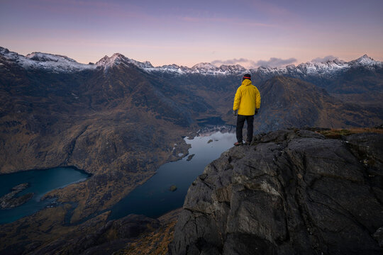 Hiker on top of mountain, Located on the Isle of Skye, Scotland.