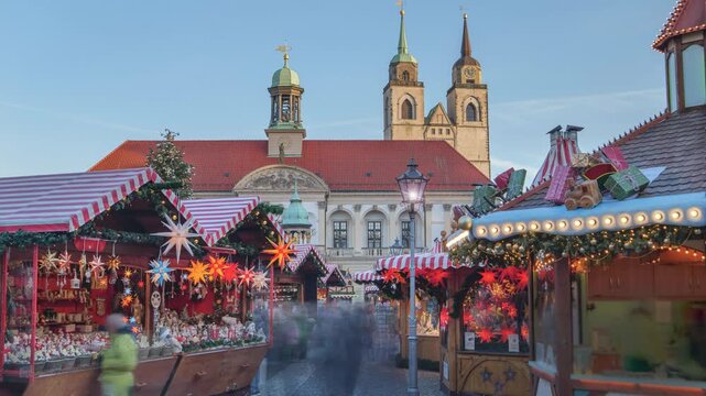 christmas market at the Old Market in Magdeburg, Germany, Saxony-Anhalt, time lapse with motion blur of people in the golden hour