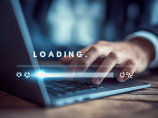 Close-up of a business person?s hand typing on a laptop keyboard with a digital loading progress bar overlay in a dimly lit office environment