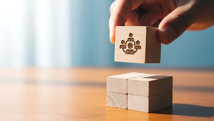 Hand placing wooden block with teamwork icon on stack, collaboration concept.