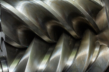 Helical screw compressor rotor lobe and its surrounding housing plate, highlighting precision...