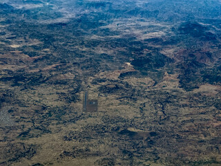 aerial landscape view of Axum Airport (IATA: AXU, ICAO: HAAX) with runway, apron and buildings, located near Axum a city in northern Ethiopia that is a UNESCO World Heritage site